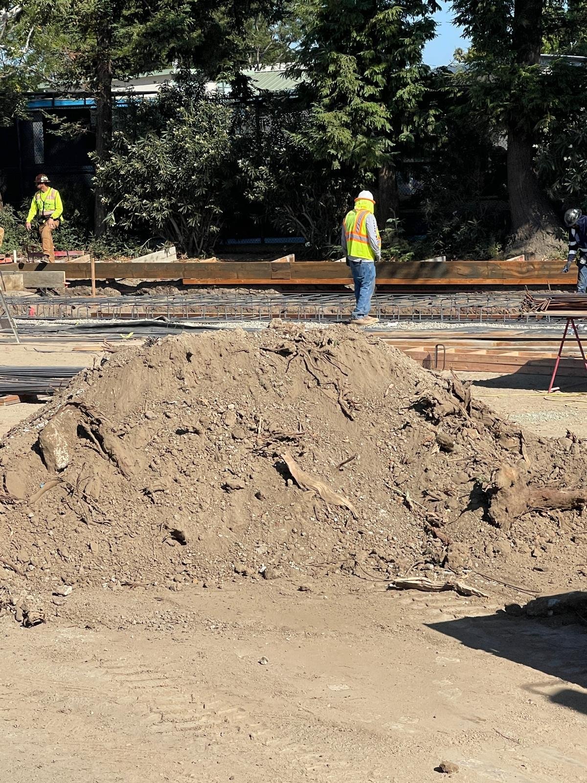 Dirt Haulers job site with dirt pile and crew